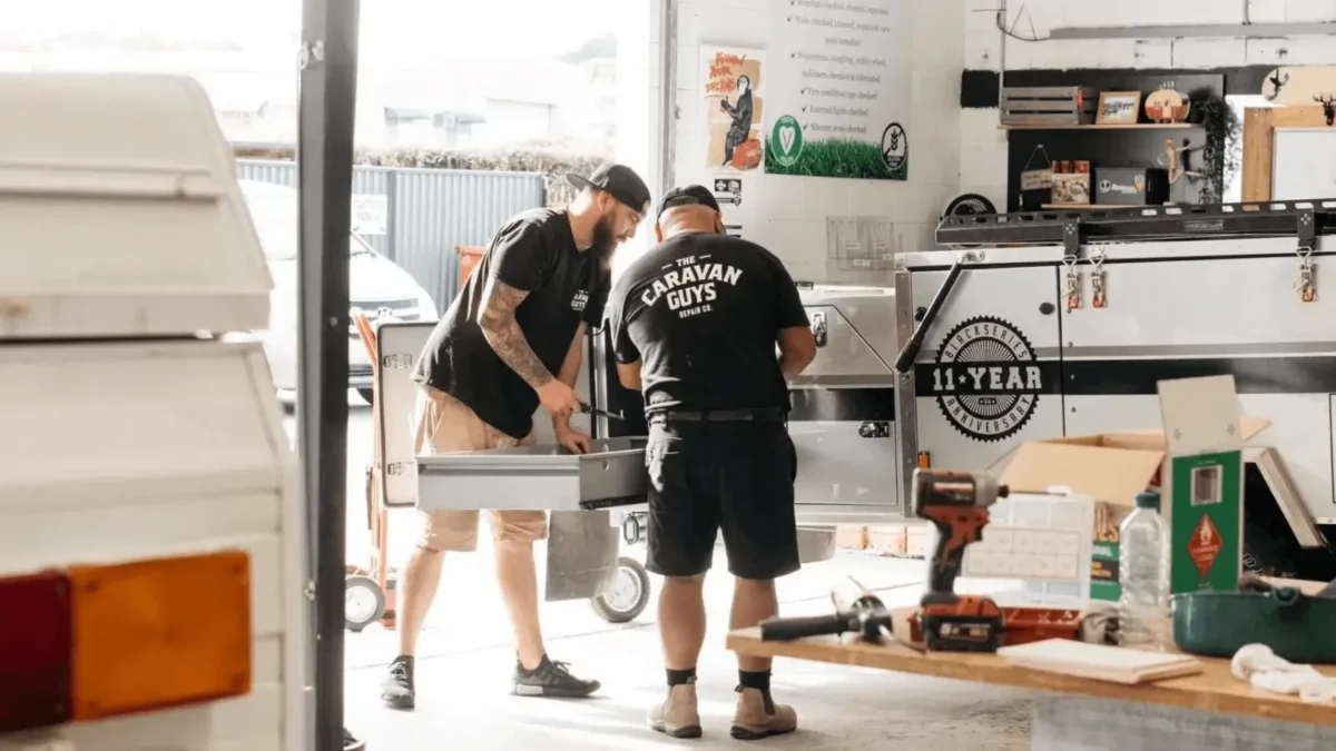 Technicians from The Caravan Guys giving a van a comprehensive health check
